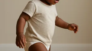 Nigerian toddler walking on tiptoes 