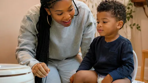 Nigerian Mother Comforting Autistic Child With Stomach Discomfort - Gut Health Signs