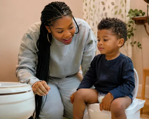 Nigerian Mother Comforting Autistic Child With Stomach Discomfort - Gut Health Signs